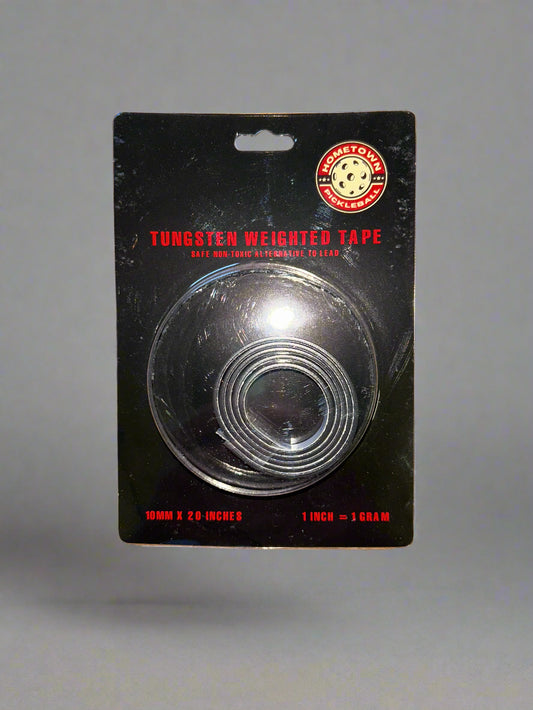 Clear round object on a black card with red text on a wooden surface