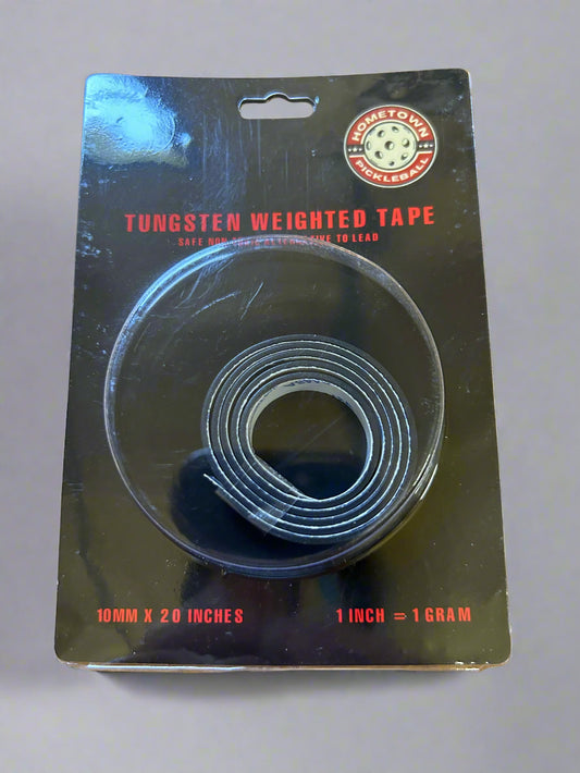 Tungsten weighted tape on a black card with red text on a wooden surface