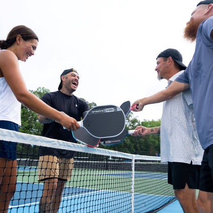 Players shaking hands at the net with the JOOLA Pro V Radius 16mm Pickleball Paddle
